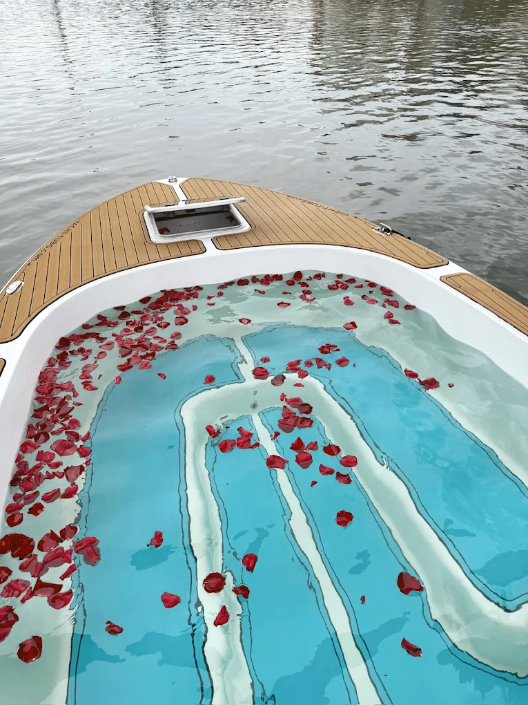 Overhead shot of hot tub with red rose petals scattered throughout