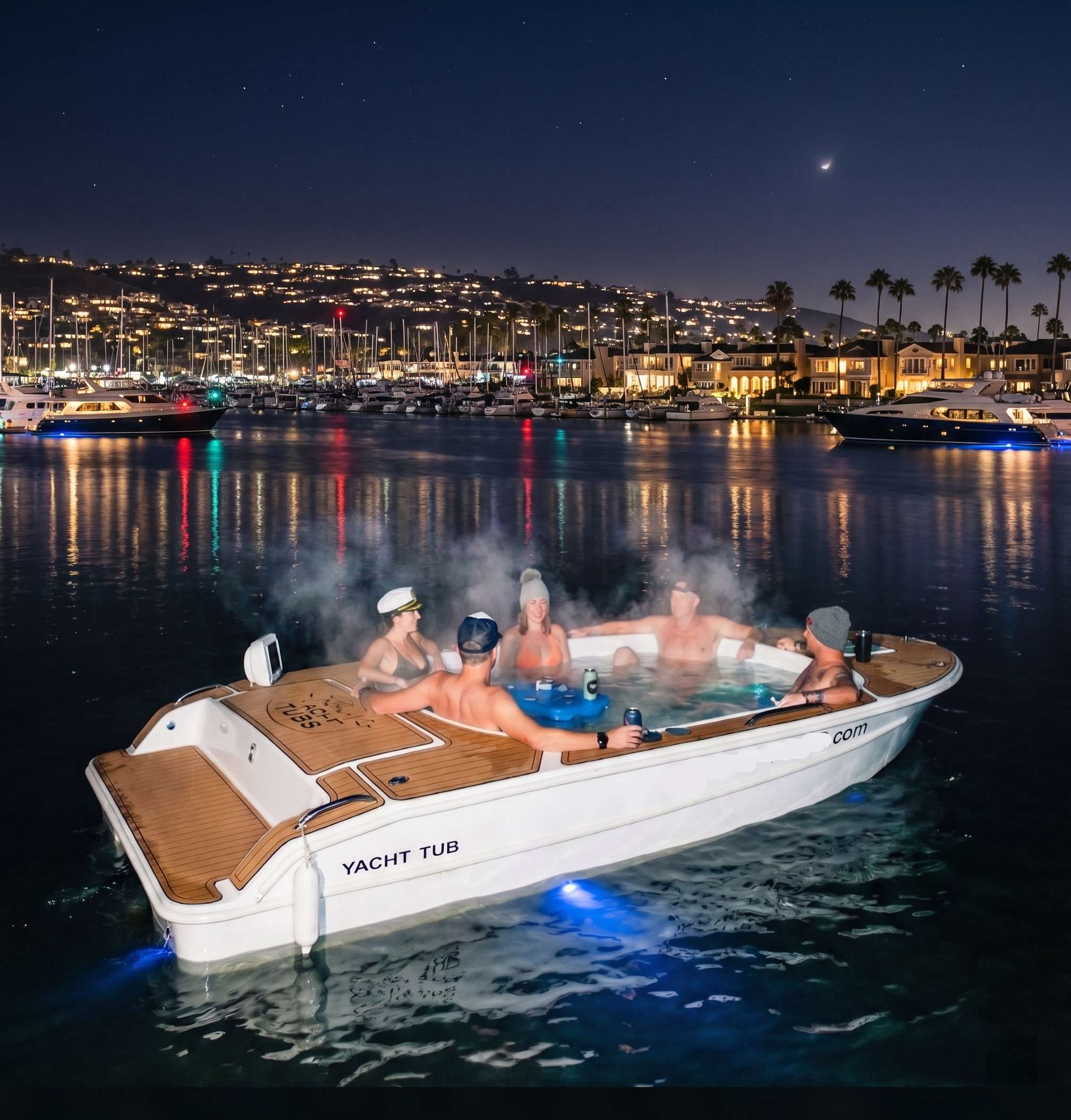 Nighttime hot tub boat cruise with glowing city lights and starry sky